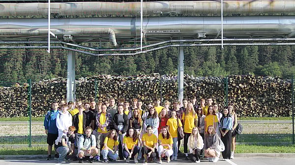 Photo of group of colleagues standing in front of a building