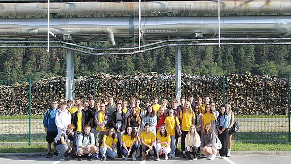 Photo of group of colleagues standing in front of a building